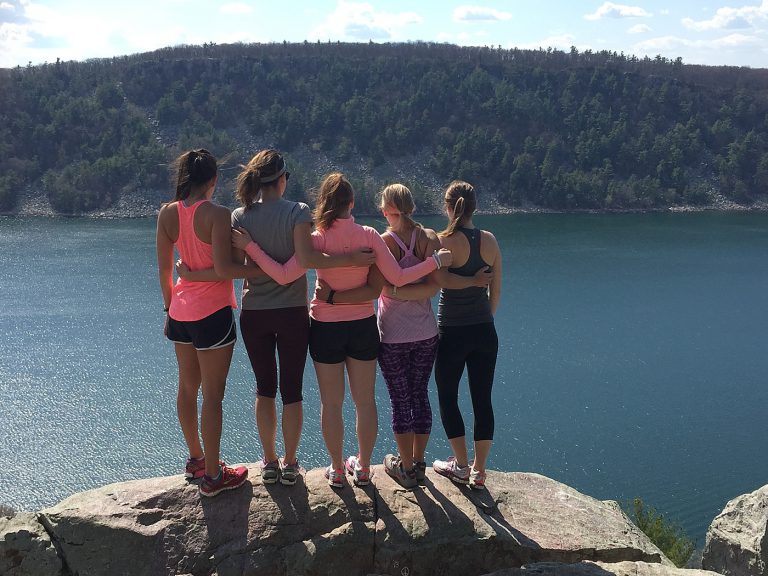 Group of woman with looking out over a lake.