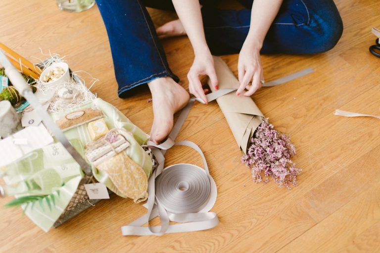 Florist putting together a bouquet on the floor.