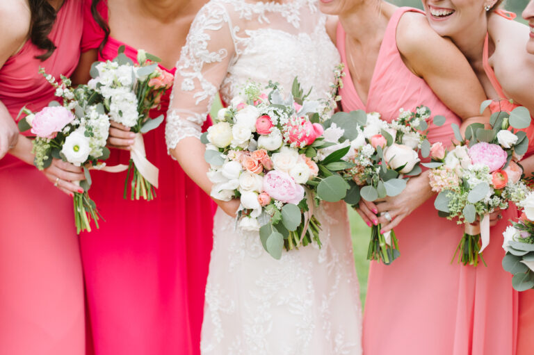 Close up of a bridal party in shades of pink with the bride in the center