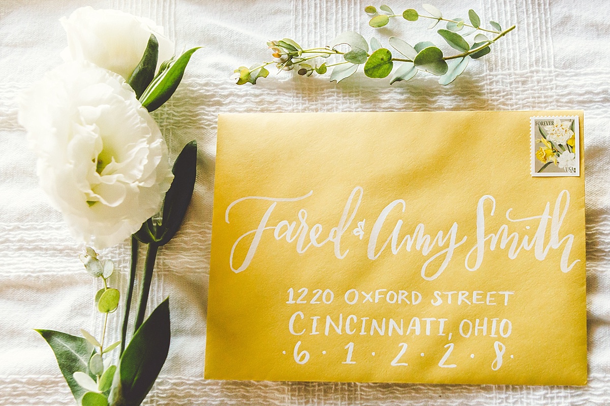 White calligraphy on a yellow envelope from Rising Tide Society Styled Shoot