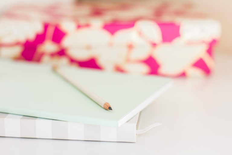 A stack of brightly colored books and paper