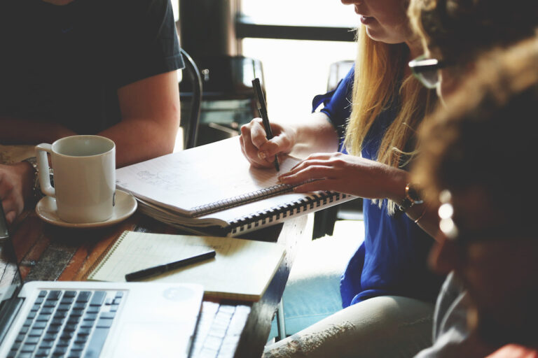 A group of people work around a table