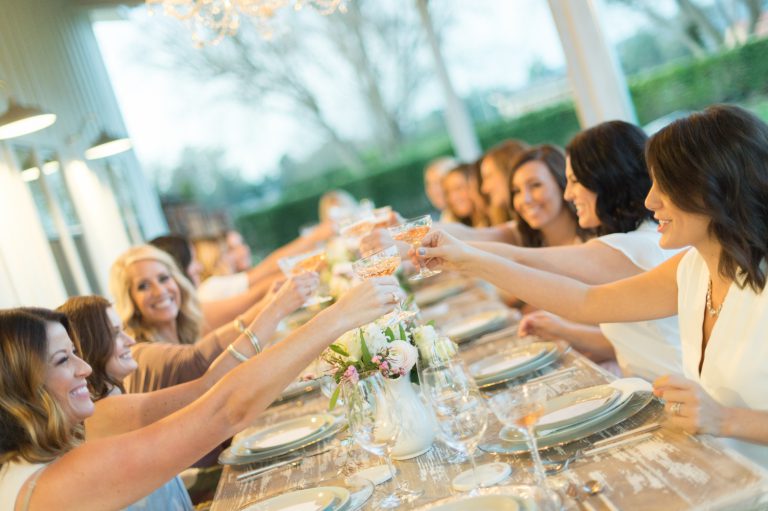 Woman at dinner party give a toast