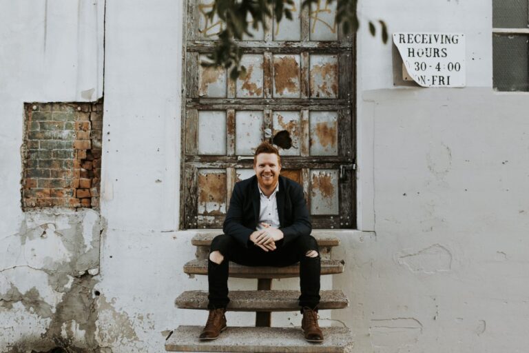 Jeff Watkins sits on staircase