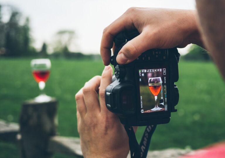 a camera screen taking a picture of a glass of wine