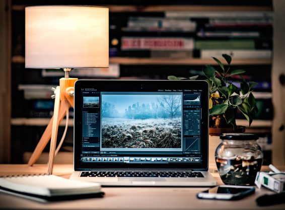 Image with laptop open on desk.