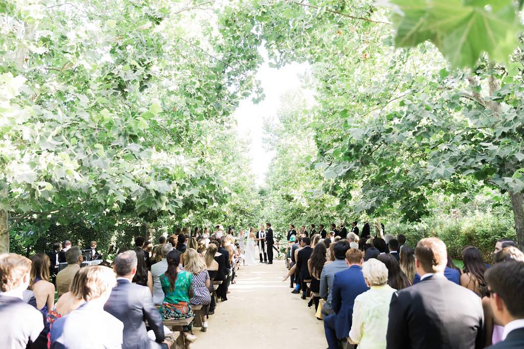 Couple getting married in an outdoor ceremony.