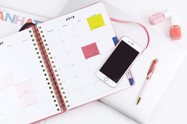 Close up of a calendar and cellphone.