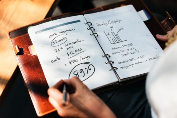 Close up of a woman analyzing business in a journal.