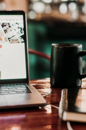 Close up of a laptop and coffee mug