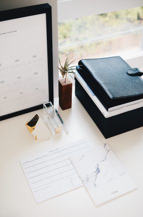 a desktop scene with notebooks and planners