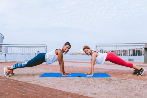 two women doing yoga