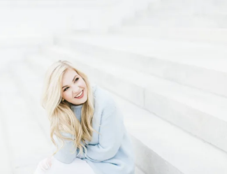 a woman smiling and learning how to improve her client booking workflow