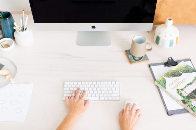 Woman with hands on keyboard and mouse.