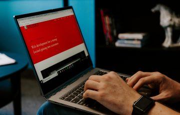 Close up of hands typing on a laptop.