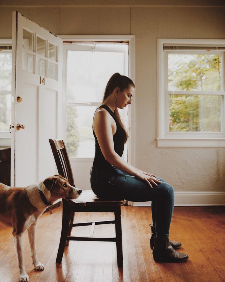 a woman seated in a chair concentrating on developing resilience