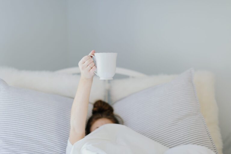 person having a cup of coffee to start their morning routine