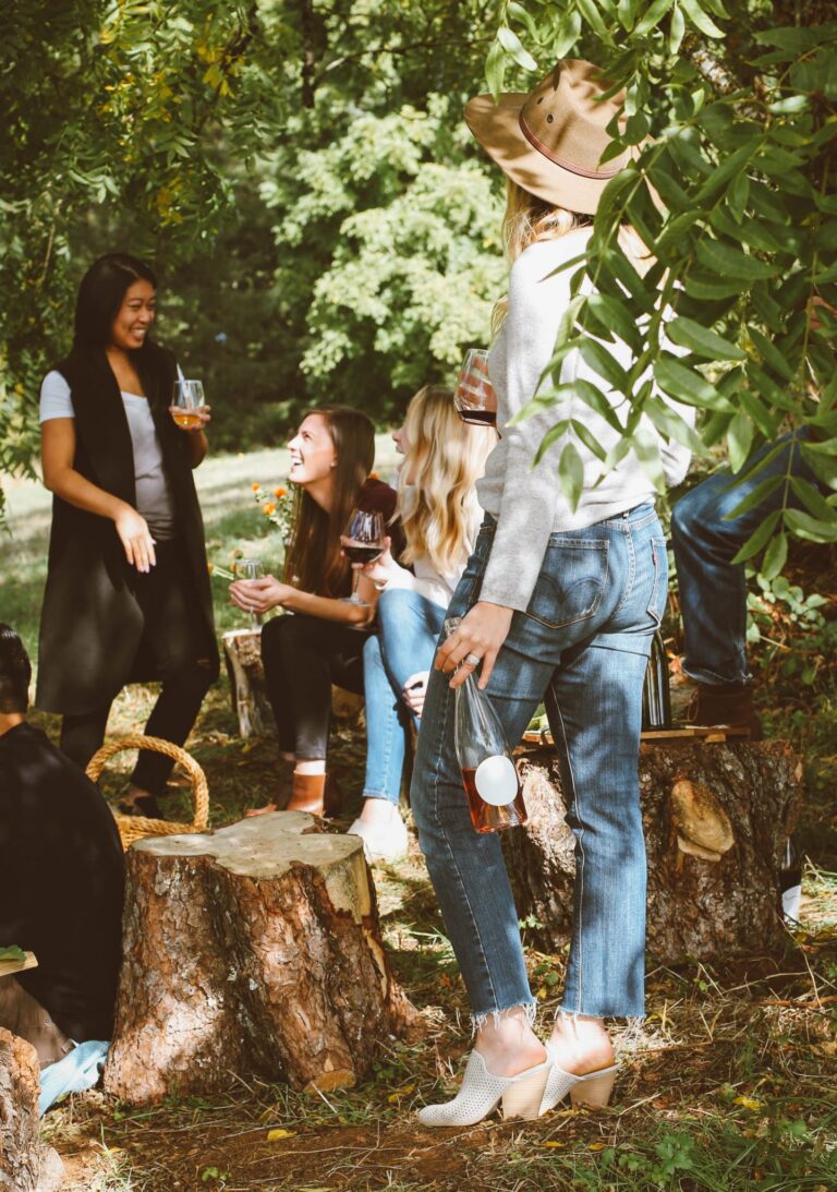 business mentor speaking with a group of people in a casual outdoor setting