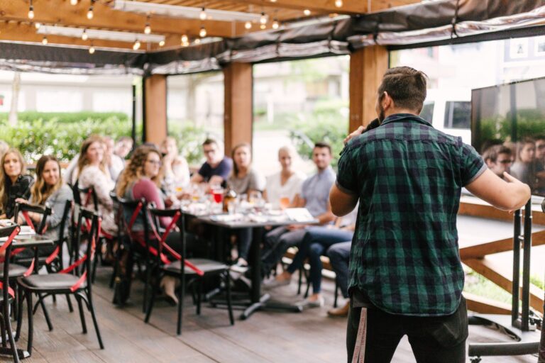 subject matter expert speaking to a group of people at a venue