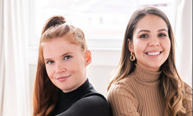 Close up of two women smiling at the camera.