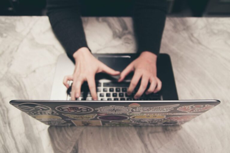 a woman typing on a laptop learning how to deal with email anxiety