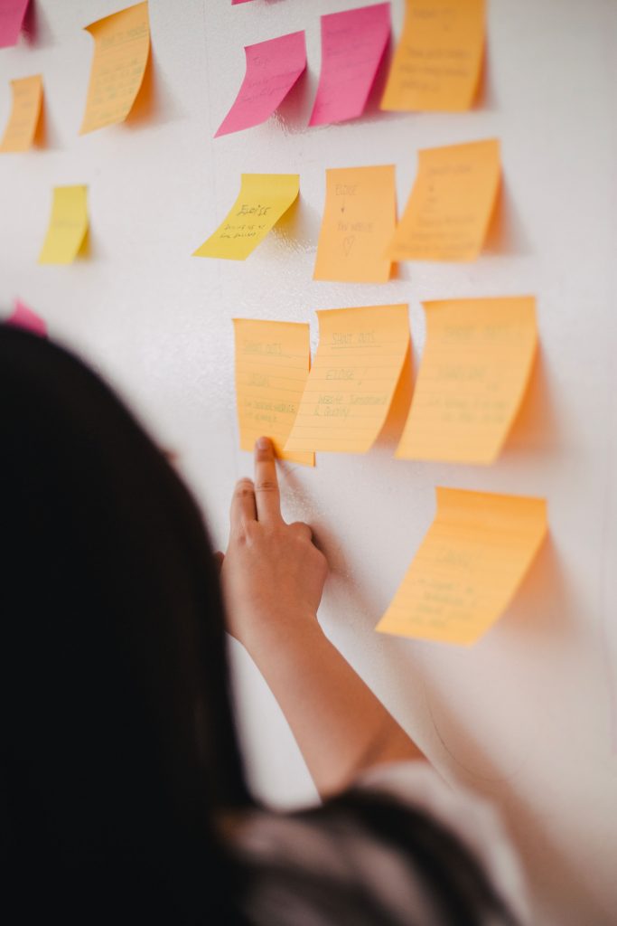 sticky notes of various colors stuck onto a whiteboard