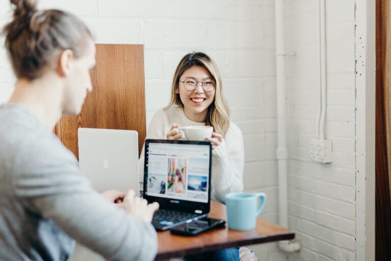 two people on laptops creating content for instagram