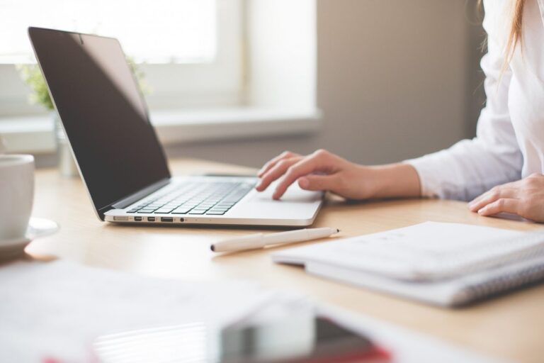 Close up of woman using laptop.