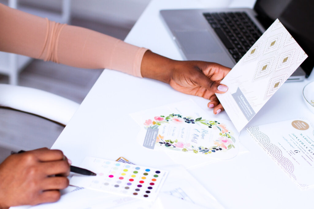 Close up of a woman's hands working with colorful stationary