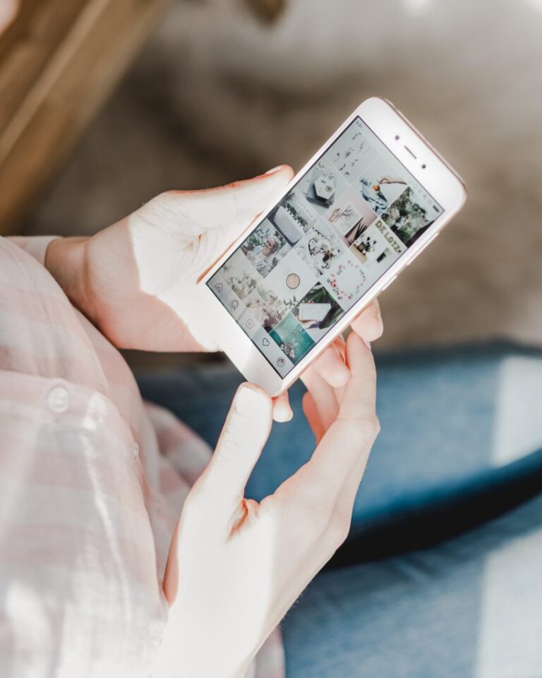 woman holding her phone looking at social media