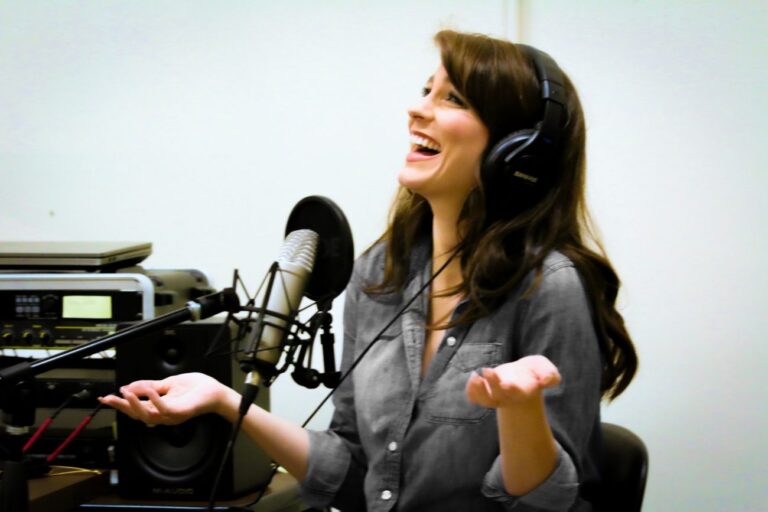 woman with headphones in front of a microphone