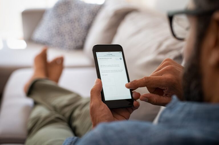 a man on a couch looking at his phone