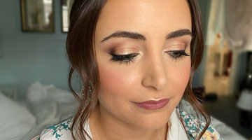 bride getting makeup work done for her wedding