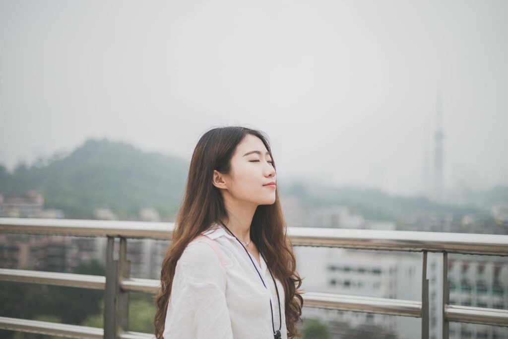 entrepreneur managing anxiety by being outside, breathing peacefully