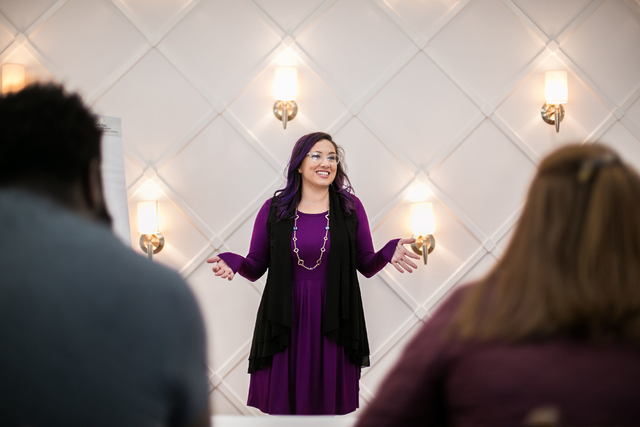 A woman gives a talk to an audience