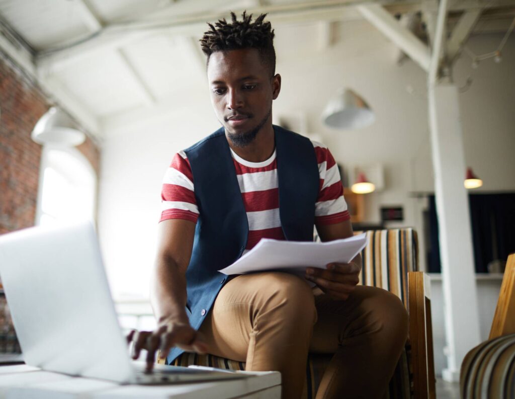 Man on his laptop using HoneyBook for independent business