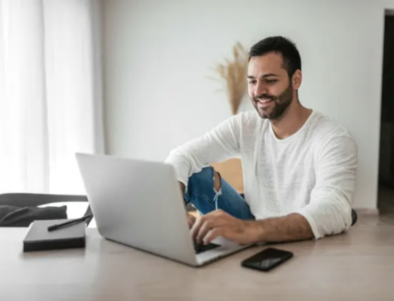 man looking at a laptop learning about year end metrics