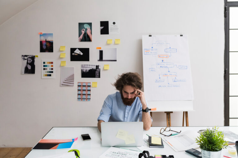 a man at a desk working to forecast his business year for success