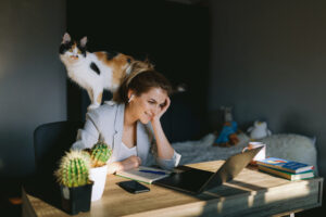Girl Working At Home With Her Cat.