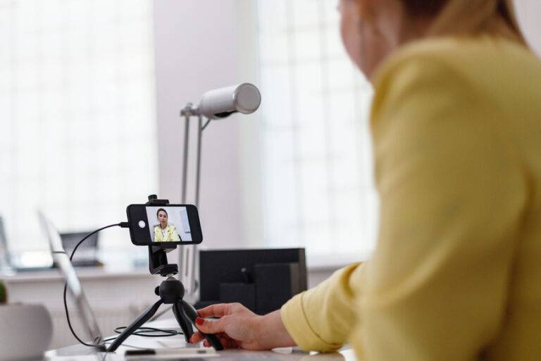 Podcaster prepping the camera and mic to record a podcast