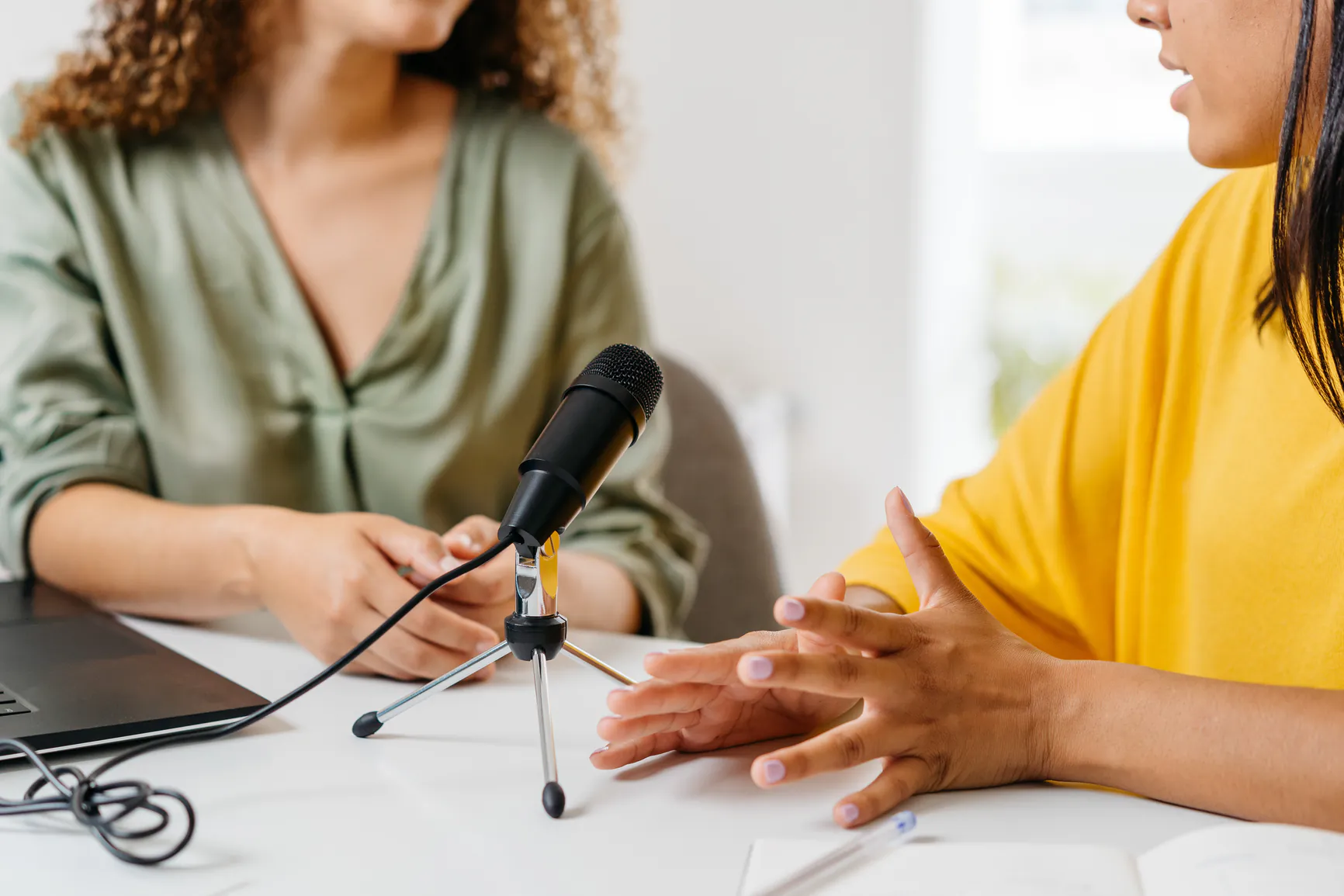 Two women talk over paperwork.