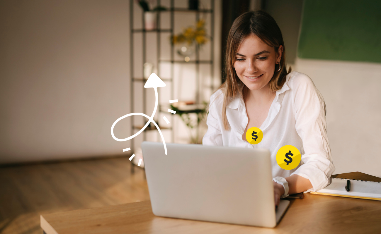 Woman sits behind a laptop looking at a screen. Dollar symbols and an arrow graphic symbolize higher conversions