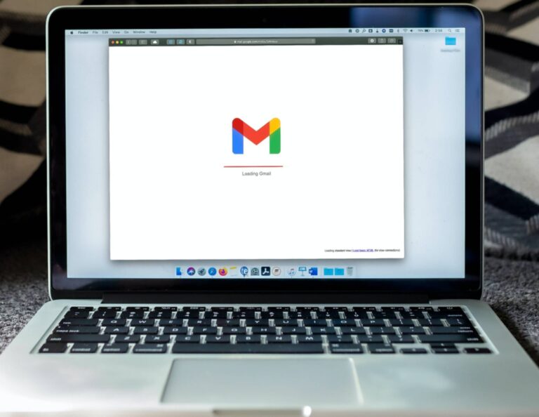 A laptop open to a Gmail loading screen.