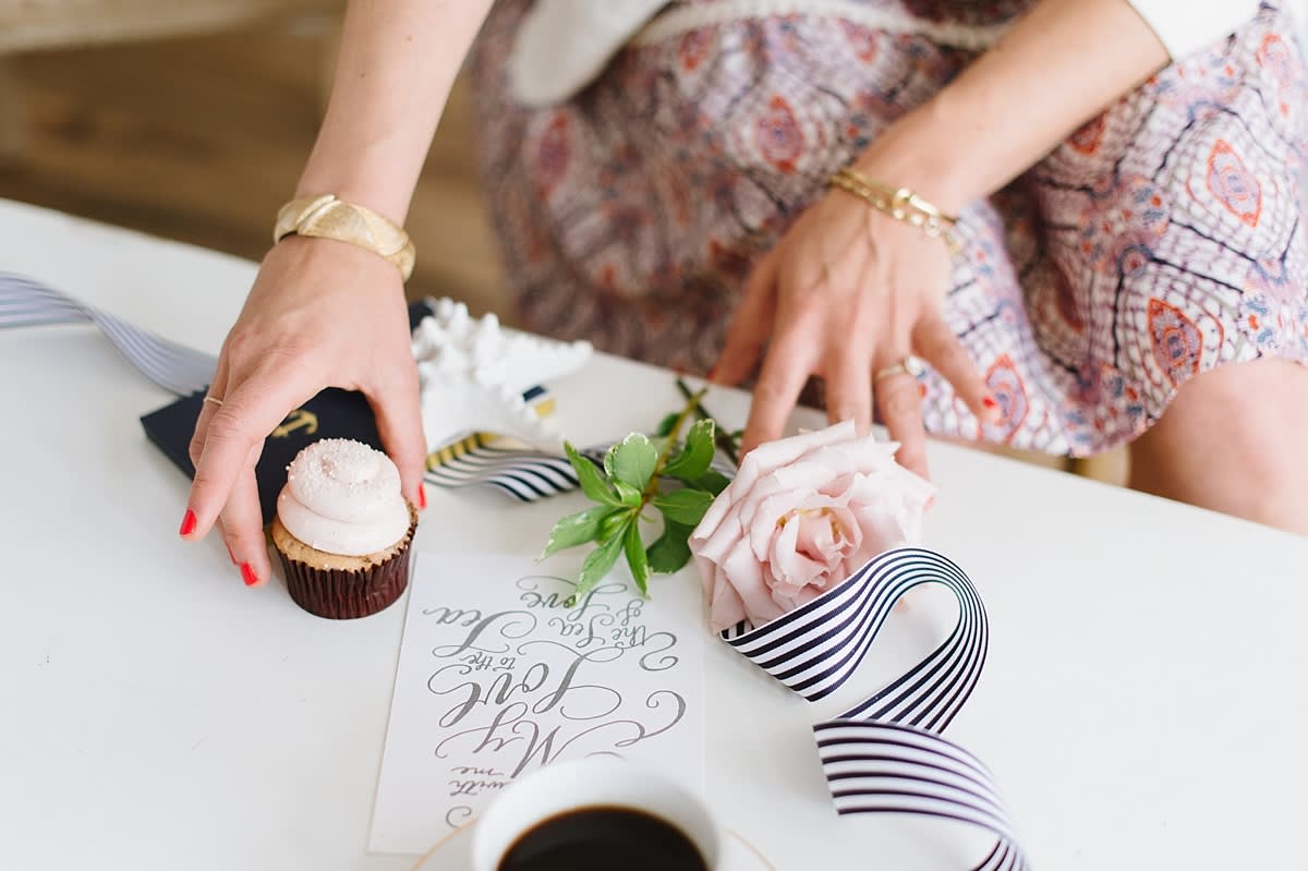 Woman styling instagram photos with a cupcake