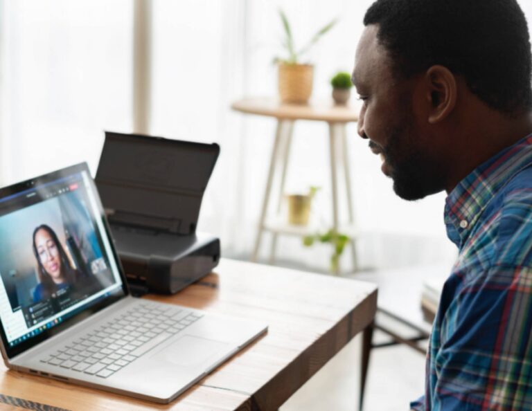 Man on computer facetiming with a woman