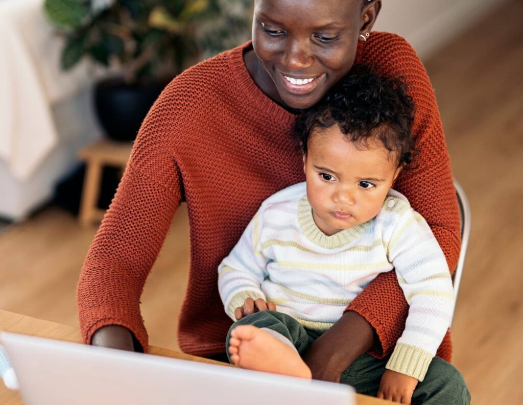 Woman holding baby before taking parental leave