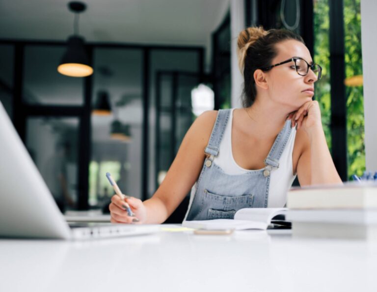 A woman procrastinating at her desk