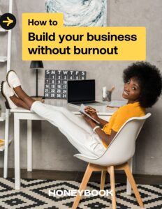 Woman puts her feet on her desk and writes in a notebook on the cover of the Build your business without burnout guide.