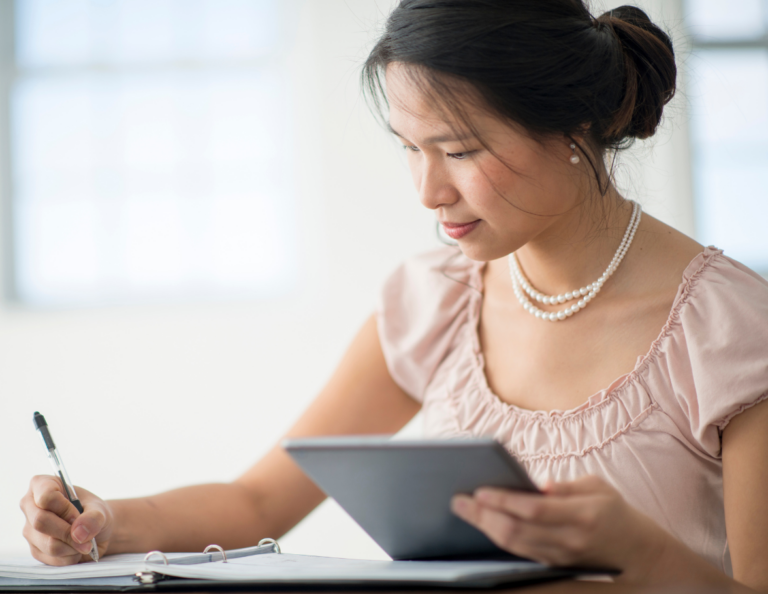 Woman writing down questions to ask clients