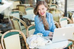 Abby Grace working at her computer, likely on something for her company Sweet Wanderings Shop